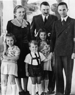 Genocidal German dictator and Nazi leader Adolf Hitler (1889 - 1945) (rear center) stands with Nazi Propaganda Minister Joseph Goebbels (1897 - 1945), his wife Magda (1901 - 1945), and their three oldest children, left to right, Hilda (1934 - 1945), Helmut (1935 - 1945), and Helga (1932 - 1945), late 1930s. (Photo by Express Newspapers/Getty Images)