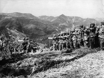 Vietnamese troops who parachuted into the area north of Dien Bien Phu await French officer instructions. (Photo by Hulton Archive/Getty Images)