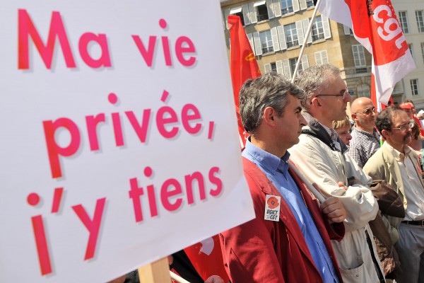 FRANCE - JULY 23:  Members of the Confederation francaise de l'encadrement-Confederation generale des cadres (CFE-CGC) union demonstrate with a sign reading "I'll keep my private life" in Paris, France, on Wednesday, July 23, 2008. Eric Pigal, like other white collars and French workers, is bracing for a dimming of France's "joie de vivre," a way of life with its plentiful leisure time as President Nicolas Sarkozy pushes to keep his campaign promise to "restore the value of work." With the passage of the law, Sarkozy has effectively sung the dirge of France's infamous 35-hour workweek.  (Photo by Antoine Antoniol/Bloomberg via Getty Images)
