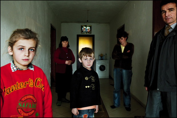 SHKODER, ALBANIA. Shitani Family: Alexander, 6 years old, Mailinda, 8, Groshe, 55, the grandmother, Vera, 31, the mather and Prof. Leka on the right side. In December 2007, Besnik, argues with his cousin for trivial reasons. In a fight with other people and definitely drunk, Besnik hits him with a knife, killing him. Besnik is in a jail, but his family will have to serve the revenge. His sons do not go to school and the teacher Leka, goes to their house to give lesson of school subjects.
